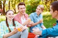 Young people eating and drinking during picnic Royalty Free Stock Photo