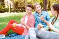 Young people eating and drinking during picnic Royalty Free Stock Photo