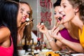 Young people eating sushi in restaurant Royalty Free Stock Photo