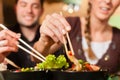 Young people eating in Thai restaurant Royalty Free Stock Photo