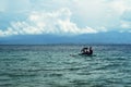 Young people enjoy riding on tiny small boat on sea Royalty Free Stock Photo