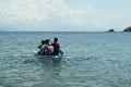 Young people enjoy riding on tiny small boat on sea