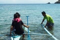 Young people enjoy riding on tiny small boat on sea