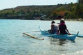 Young people enjoy riding on tiny small boat on sea