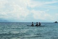 Young people enjoy riding on tiny small boat on sea