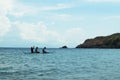 Young people enjoy riding on tiny small boat on sea