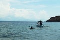 Young people enjoy riding on tiny small boat on sea