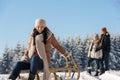 Young people enjoy sunny winter snow sledge Royalty Free Stock Photo