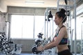 Young people exercising in the gym. asian body builder working out in gym using fitness straps in the gym center Royalty Free Stock Photo