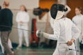 Young people fencers standing in the hall on a fencing tournament
