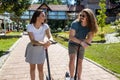 Young people flirting as they have fun with two wheel scooters Royalty Free Stock Photo
