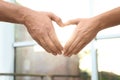 Young people forming heart with hands indoors. Happy family Royalty Free Stock Photo