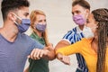 Young people friends bump their elbows instead of greeting with a hug - Avoid the spread of coronavirus, social distance and