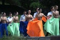 Young people going to a stage to dance waltz. Costume ball of high-school graduates