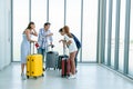 Young people group in airport lounge near windows waiting departure speaking happy smile with friends Royalty Free Stock Photo