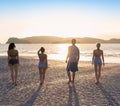 Young People Group On Beach At Sunset Summer Vacation, Friends Walking Seaside Back Rear View Royalty Free Stock Photo