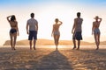 Young People Group On Beach At Sunset Summer Vacation, Friends Walking Seaside Back Rear View Royalty Free Stock Photo