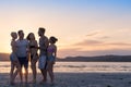 Young People Group On Beach At Sunset Summer Vacation, Happy Smiling Friends Walking Seaside Royalty Free Stock Photo