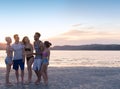 Young People Group On Beach At Sunset Summer Vacation, Happy Smiling Friends Walking Seaside Royalty Free Stock Photo