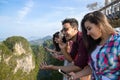 Young People Group In Mountain Using Cell Smart Phone Chatting Online Friends Asian Holiday Summer Royalty Free Stock Photo