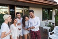 Young People Group On Terrace Tropical Hotel, Friends Using Cell Smart Phone Tropic Holiday Vacation Royalty Free Stock Photo