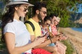 Young People Group Using Cell Smart Phones Tropical Park Palm Trees Friends Chatting Online Holiday Sea Summer Vacation Royalty Free Stock Photo