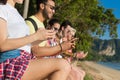 Young People Group Using Cell Smart Phones Tropical Park Palm Trees Friends Chatting Online Holiday Sea Summer Vacation Royalty Free Stock Photo