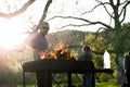 Young people having barbecue out in the garden on labor day