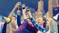 Young people having fun drinking red wine at night party while throwing confetti Royalty Free Stock Photo