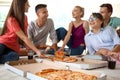 Young people having fun at party with delicious pizza indoors Royalty Free Stock Photo