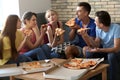 Young people having fun at party with delicious pizza indoors Royalty Free Stock Photo