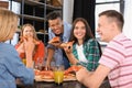 Young people having fun at party with delicious pizza indoors Royalty Free Stock Photo