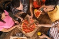 Young people having fun at party with delicious pizza indoors Royalty Free Stock Photo