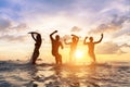 Young people having fun splashing water in the sea, friends Royalty Free Stock Photo