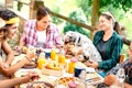 Young people on healthy pic nic breakfast with cute puppy at countryside farm house - Alternative lifestyle concept Royalty Free Stock Photo