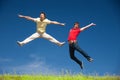 Young people jump on hill in park Royalty Free Stock Photo