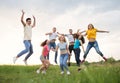 Young people jumping against the sunset sky Royalty Free Stock Photo