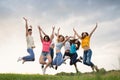 Young people jumping against the sunset sky Royalty Free Stock Photo
