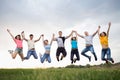 Young people jumping against the sunset sky Royalty Free Stock Photo