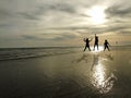 Young people jumping on the beach with sunset background Royalty Free Stock Photo