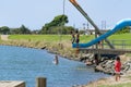 Young people jumping into Waioeka River enjoying summer fun Royalty Free Stock Photo