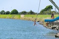 Young people jumping into Waioeka River enjoying summer fun Royalty Free Stock Photo