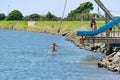 Young people jumping into Waioeka River enjoying summer fun Royalty Free Stock Photo