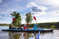 Young people are kayaking on a river in beautiful nature. Summer sunny day Royalty Free Stock Photo