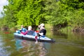 Young people are kayaking on a river in beautiful nature. Summer sunny day