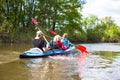 Young people are kayaking on a river in beautiful nature. Summer sunny day Royalty Free Stock Photo