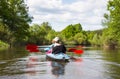 Young people are kayaking on a river in beautiful nature. Summer sunny day Royalty Free Stock Photo