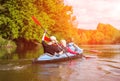 Young people are kayaking on a river in beautiful nature. Summer sunny day Royalty Free Stock Photo