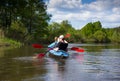 Young people are kayaking on a river in beautiful nature. Summer sunny day Royalty Free Stock Photo