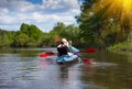 Young people are kayaking on a river in beautiful nature. Summer sunny day Royalty Free Stock Photo